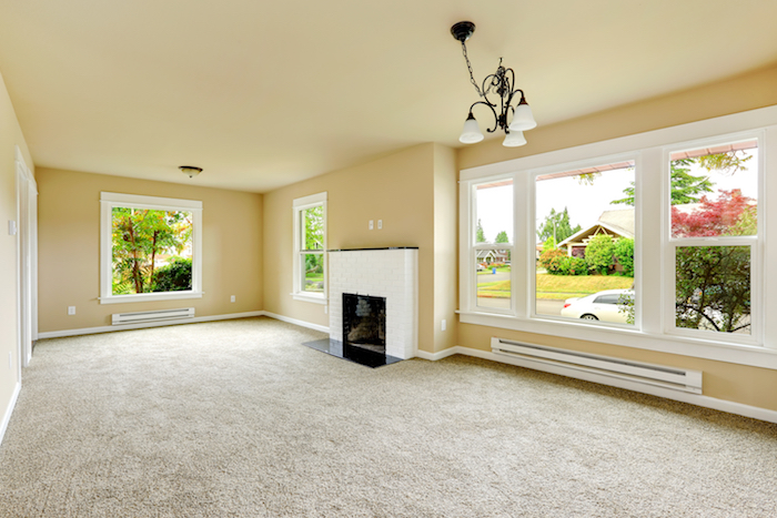 beige room with white fireplace and windows trimmed in white