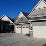 home with three garage doors and siding