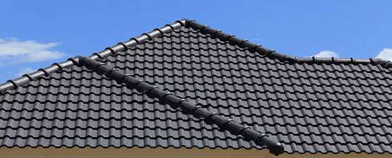 Black Tiles Roof On A New House With Blue Sky