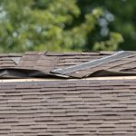 roof that requires storm damage repair with broken shingles